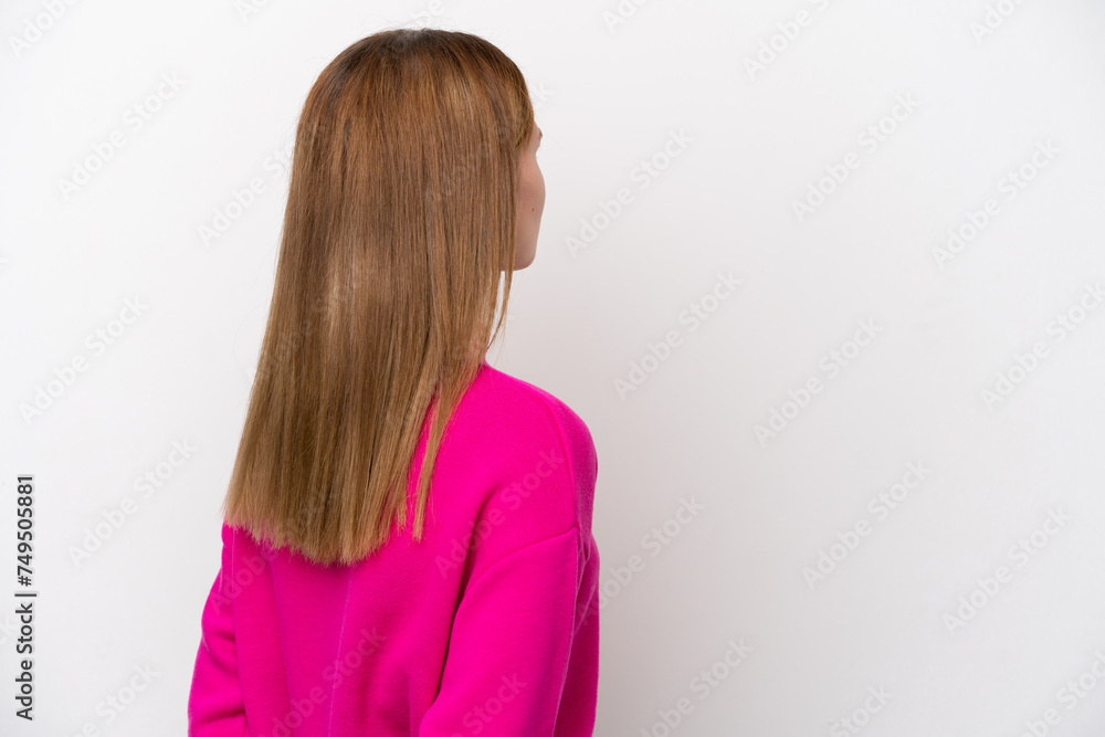 Young English woman isolated on white background in back position and looking back Young English woman isolated on white background in back position and looking back