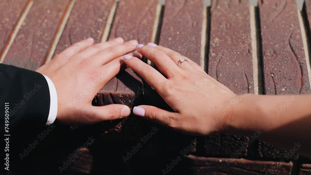 The girl gently runs her hand over her man's arm. The camera takes the hands of lovers in close-up The girl gently runs her hand over her man's arm. The camera takes the hands of lovers in close-up