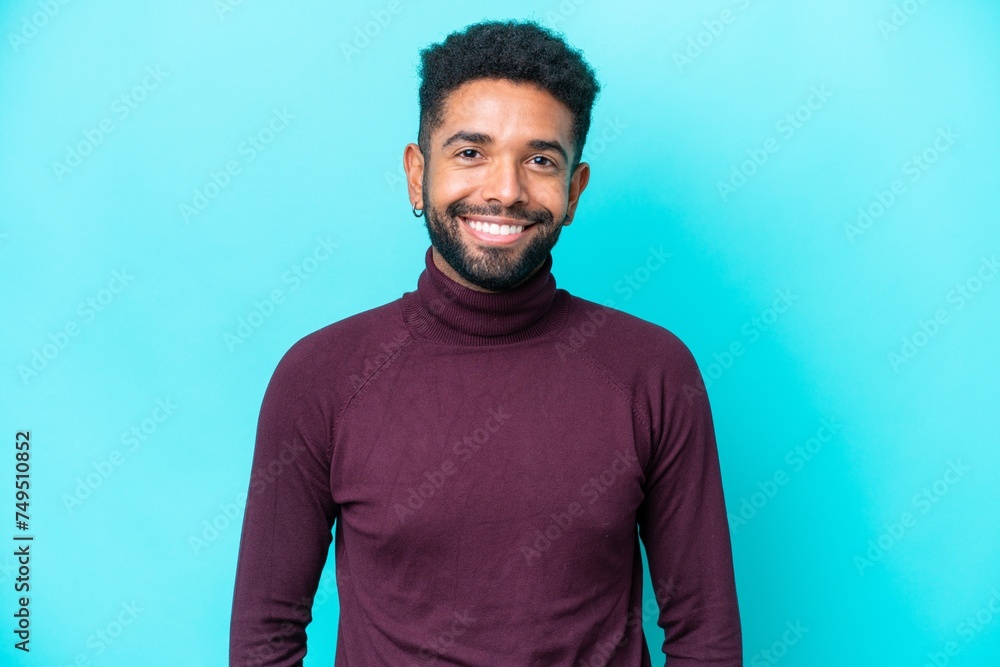 Young Brazilian man isolated on blue background laughing Young Brazilian man isolated on blue background laughing