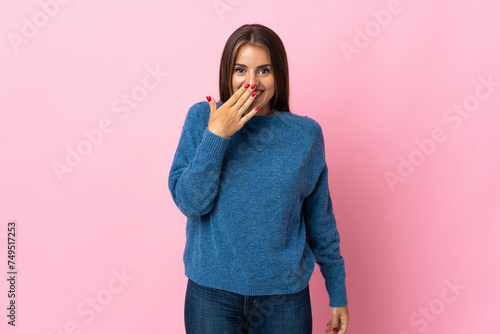 Young Uruguayan woman isolated on pink background happy and smiling covering mouth with hand