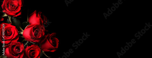 Bouquet of red roses on a black background, top view with copy space. Beautiful flowers. Banner