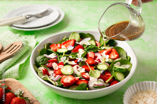 Strawberry spinach salad on a green background