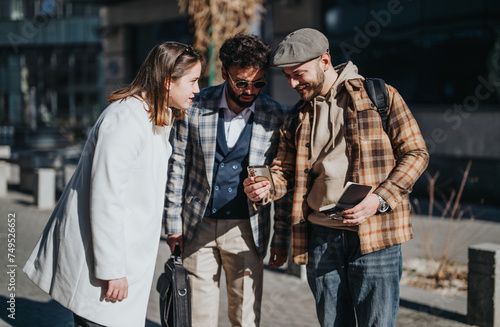 Three young professionals engage in a serious outdoor business meeting, analyzing data and strategizing for increased profitability.