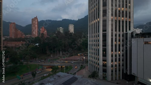 Traffic passes through the heart of Bogota, Colombia surrounded by mountains and skyscrapers photo