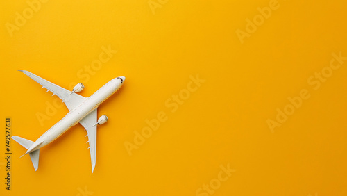 Toy Airplane on Bright Yellow Background, Symbolizing Travel and Exploration. The minimalistic design emphasizes adventure and the joy of flying
