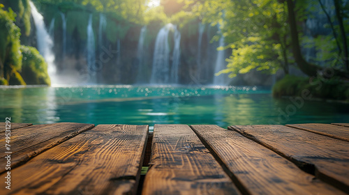 The empty wooden jetty in the foreground with a blurred background of a waterfall