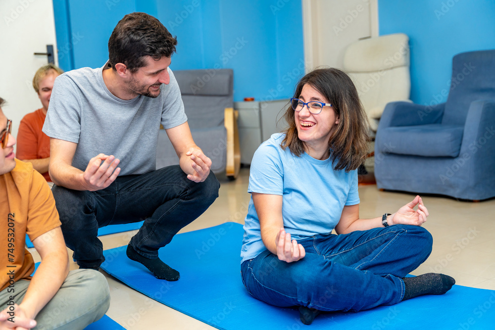 Yoga instructor teaching the lotus position to a disabled woman