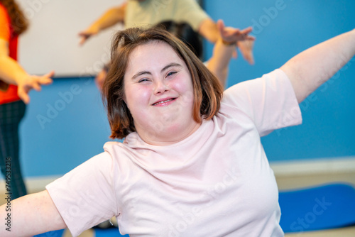 Woman with down syndrome smiling at camera in the gym