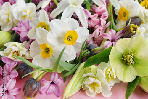 Blossoming white and light yellow daffodils, pink hyacinths and spring flowers festive background, bright springtime bouquet floral card, selective focus, shallow DOF