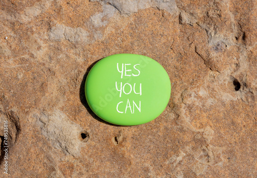 Motivational and Yes you can symbol. Concept words Yes you can on beautiful big green stone. Beautiful red stone background. Business motivational and Yes you can concept. Copy space.