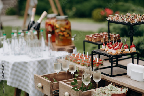 Food, a beautifully decorated catering banquet table with a variety of appetizers with cheese, ham, prosciutto and fruit. At a corporate, Christmas, birthday or wedding celebration. Buffet table. Buff