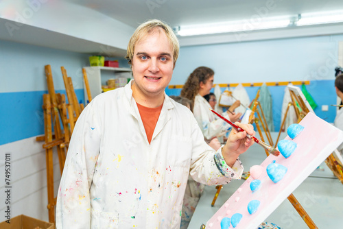 Portrait of a mental disabled man in the painting class