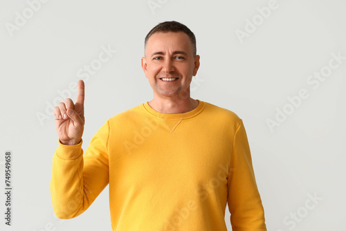 Mature man pointing at some...