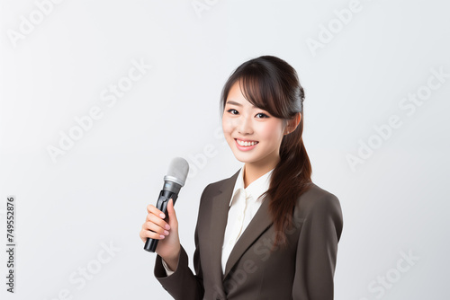 Teen pretty Japanese girl over isolated white background as a reporter holding a microphone and reporting news