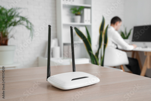 Obraz na płótnie Modern wi-fi router on table in office, closeup