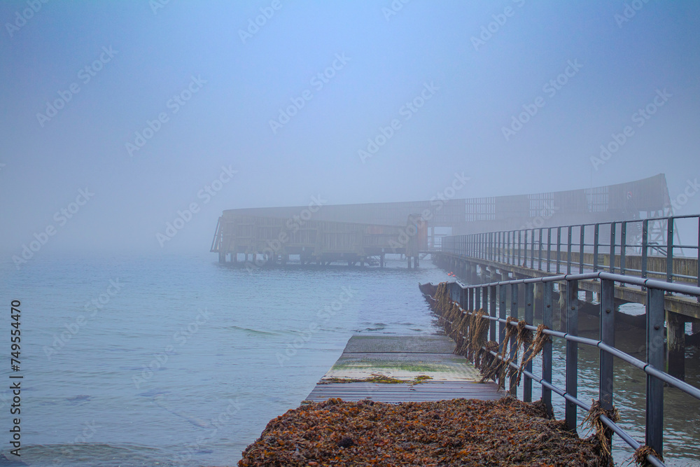 pier on the beach in the haze