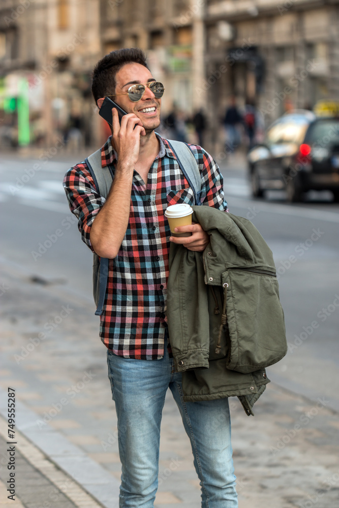 Fototapeta premium Hipster talking on mobile phone. Planning my weekend