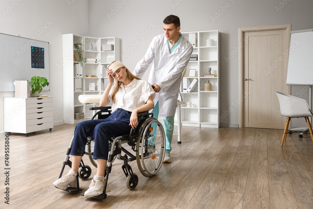 Young woman with brain concussion in wheelchair and doctor at hospital Young woman with brain concussion in wheelchair and doctor at hospital