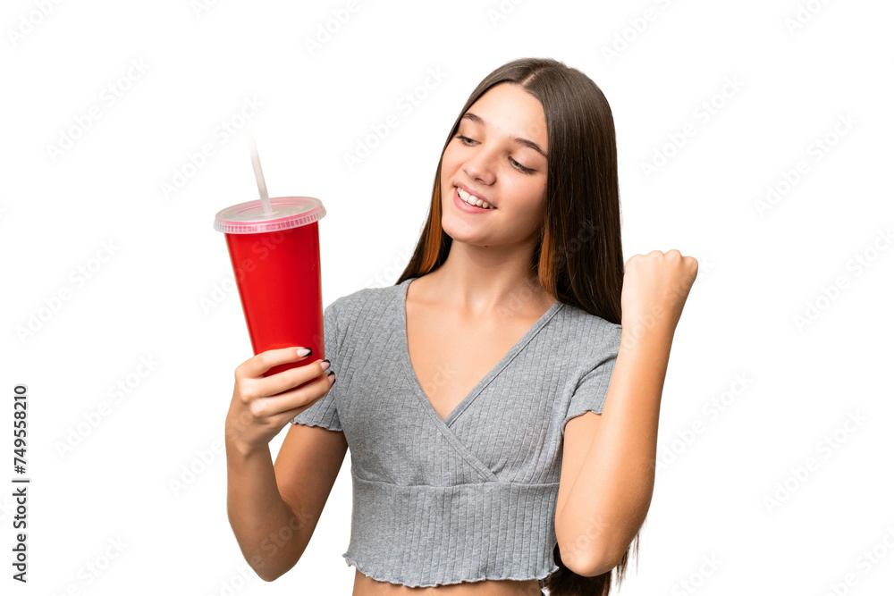 Teenager caucasian girl holding a soda over isolated background celebrating a victory Teenager caucasian girl holding a soda over isolated background celebrating a victory
