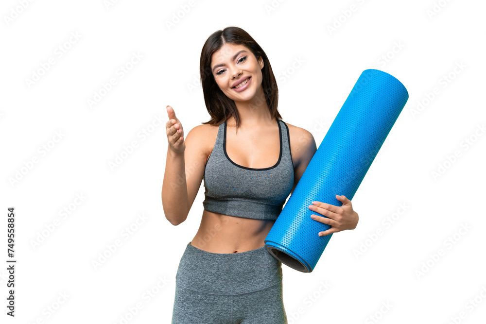 Young sport woman going to yoga classes while holding a mat over isolated chroma key background shaking hands for closing a good deal Young sport woman going to yoga classes while holding a mat over isolated chroma key background shaking hands for closing a good deal
