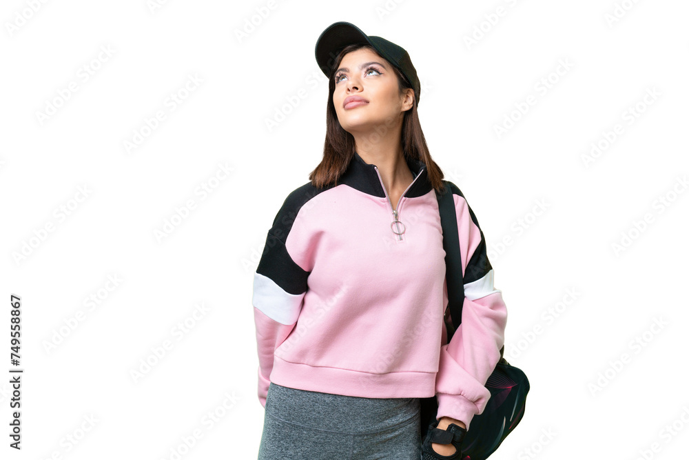 Young sport woman with sport bag over isolated chroma key background and looking up Young sport woman with sport bag over isolated chroma key background and looking up