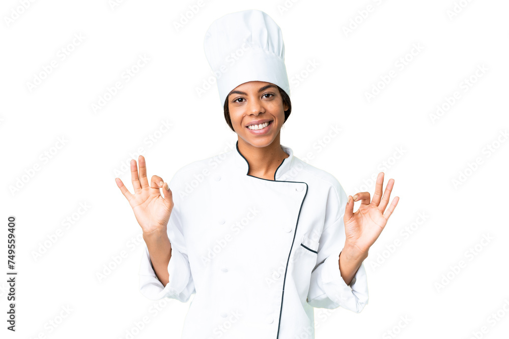 Young African American chef over isolated chroma key background showing an ok sign with fingers Young African American chef over isolated chroma key background showing an ok sign with fingers