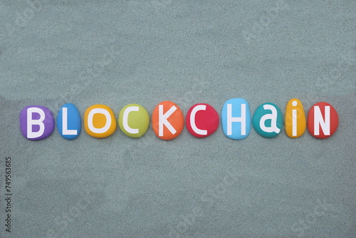 A blockchain is a distributed ledger with growing lists of records, blocks, that are securely linked together via cryptographic hashes, creative text composed with multi colored stone letters 