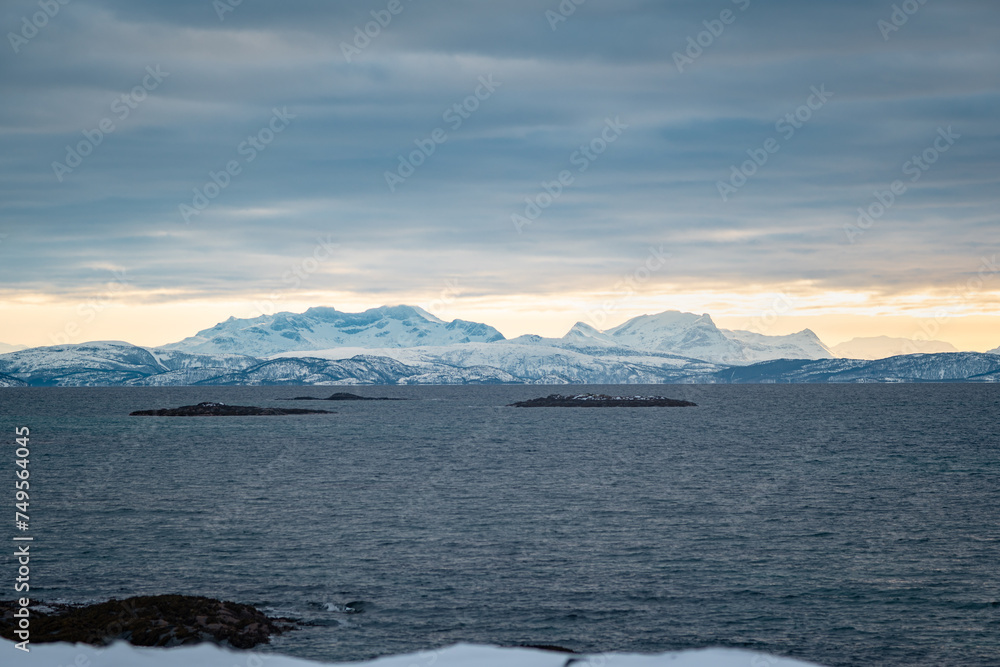Magnificent views of distant snow-capped mountains on Vestfjorden on the Lofoten Islands in Norway