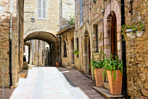 Beautiful street in the medieval old town of Assisi  with covered walkway  Umbria  Italy