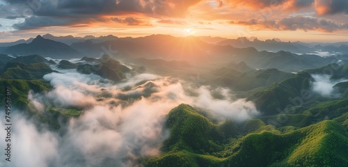 mountain landscape at sunrise with low clouds over the valley and fog