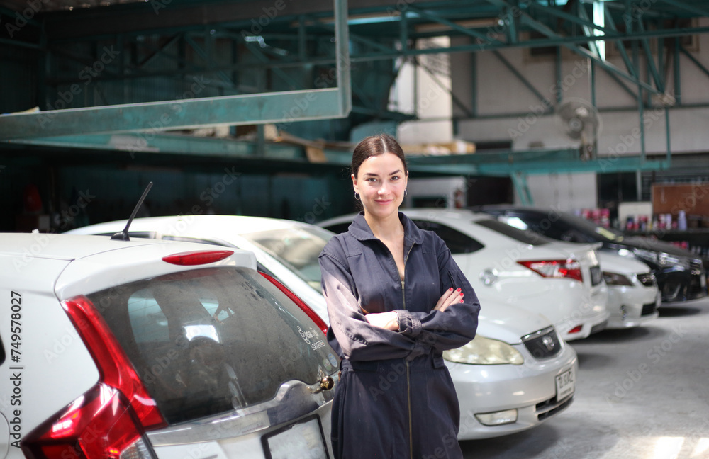 Auto mechanic working in garage. Repair service. Worker mechanics in uniform are working in auto service with lifted vehicle. Car repair maintenance. Auto mechanic working in garage. Repair service. Worker mechanics in uniform are working in auto service with lifted vehicle. Car repair maintenance.