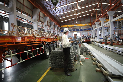 Obraz na płótnie worker or engineer working in factory with safety uniform , safety hat and safety glasses , image is safety concept or happy workplace w salonie