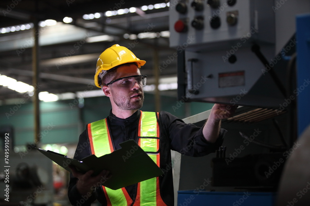 worker or engineer working in factory with safety uniform , safety hat and safety glasses , image is safety concept or happy workplace worker or engineer working in factory with safety uniform , safety hat and safety glasses , image is safety concept or happy workplace