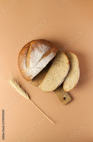 Bread. Bread and an ear of corn. Brown background. Pieces of bread.