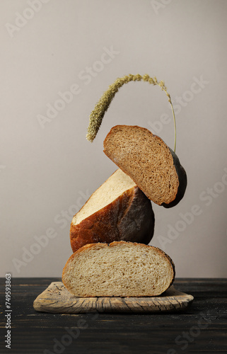 Bread. Levitation. Balance. Bread and an ear of corn. Gray background. Loaf of bread.