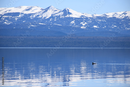 Beautiful landscape of a calm lake and snowed mountains