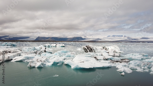 Floating icebergs in the Jökulsárlón Glacier Lagoon against cloudy sky, in southeast Iceland, on the edge of Vatnajökull National Park in Iceland.