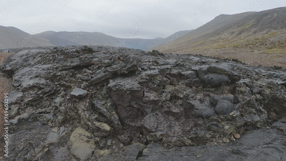 View of cracked lava crust or ingenious rock and steam cooled down from the 2021 eruption of Fagradalsfjall volcano in Geldingadalir Valley on Reykjanes Peninsula in Iceland.