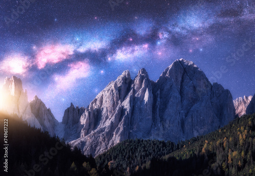 Milky Way and beautifull rocks at starry night in summer in Dolomites, Italy. Landscape with blue sky with stars, bright milky way, moonrise over high alpine rocky mountains, forest. Space. Nature