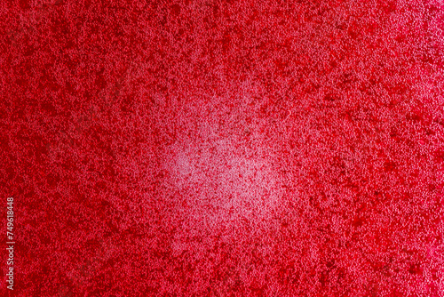 Bubbles on the surface of the drink of red raspberries soda drink on background. Fresh drink of scarlet cranberry or cherry or red currant or viburnum, closeup, top view photo