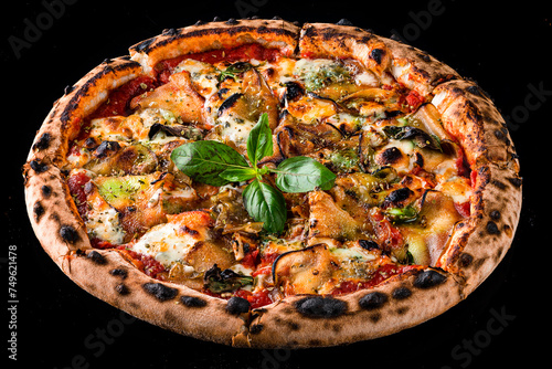 Italian dinner pizza with eggplant, cheese, tomatoes, basil, tomato sauce and spices isolated on black.