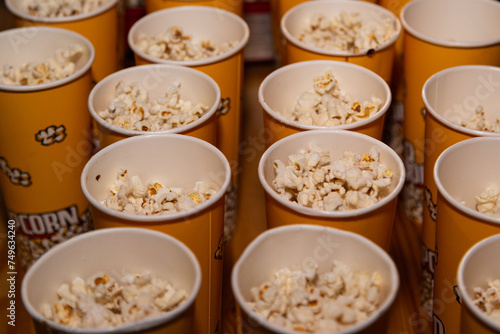 Assorted sizes of popcorn buckets in a row, ready for movie time, with a focus on the delicious, fluffy popped kernels