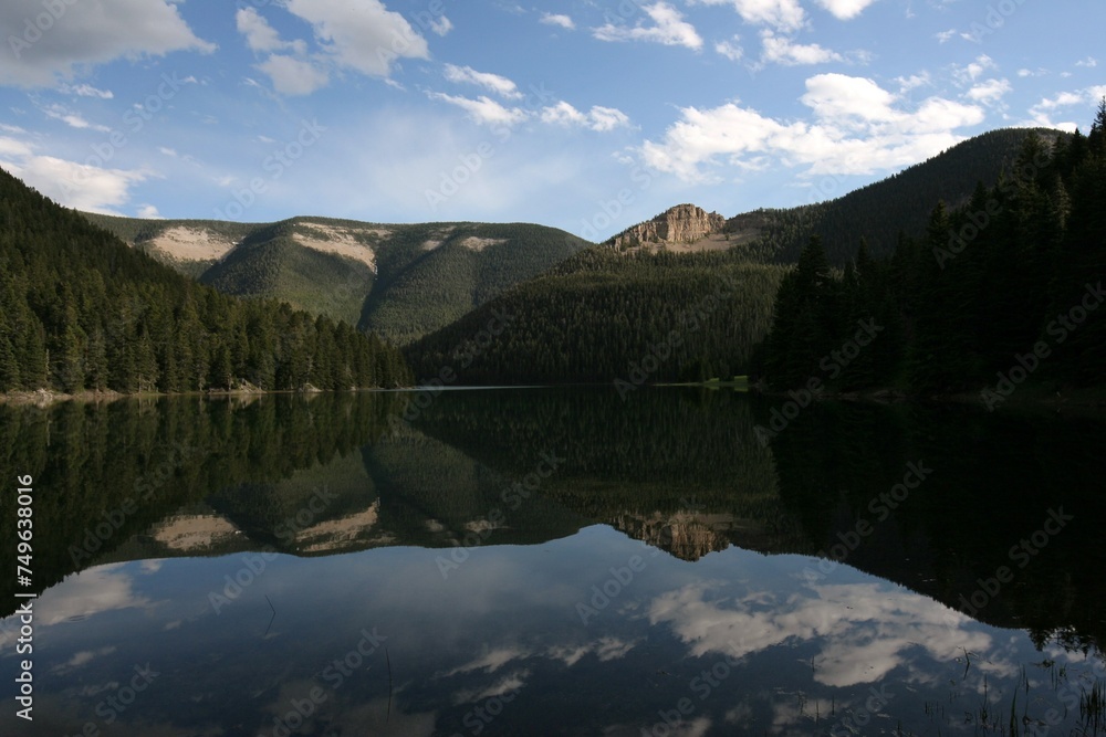 Fototapeta premium Reflection of mountains on Crystal Lake Montana