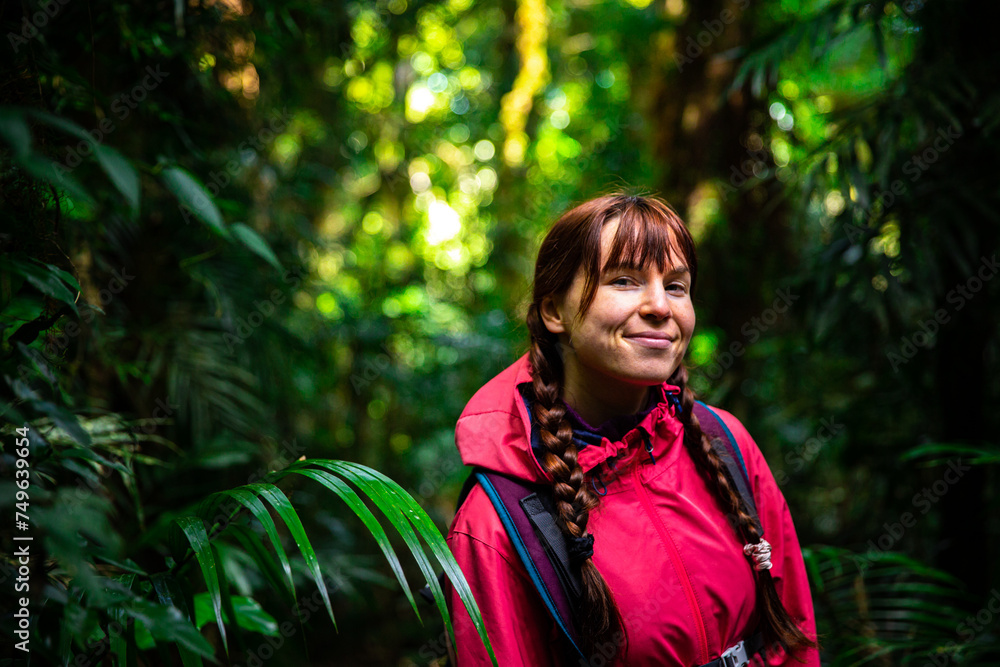 portrait of beautiful smiling girl in tropical rainforest in australia, albert river cirquit; gondwana rainforest in lamington national park, queensland, near brisbane and gold coast portrait of beautiful smiling girl in tropical rainforest in australia, albert river cirquit; gondwana rainforest in lamington national park, queensland, near brisbane and gold coast