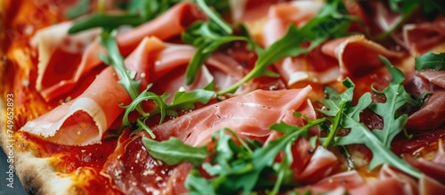 A detailed view of a freshly baked pizza covered with vibrant green arugula leaves and slices of savory dry cured ham, creating a mouth-watering and visually appealing dish.