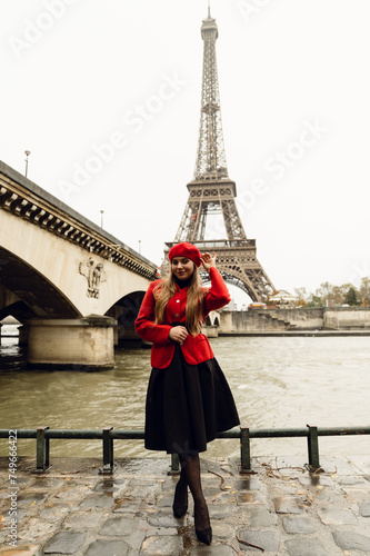 happy young girl in a red beret posing in front of the elf tower in the autumn season. visit to Paris. vertical photo.city of romance. walk in Paris.