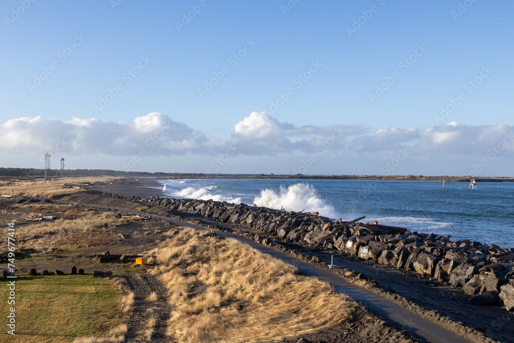 Waves crash along shore wall