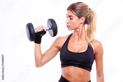 Sports girl with dumbbells in her hands on a light background