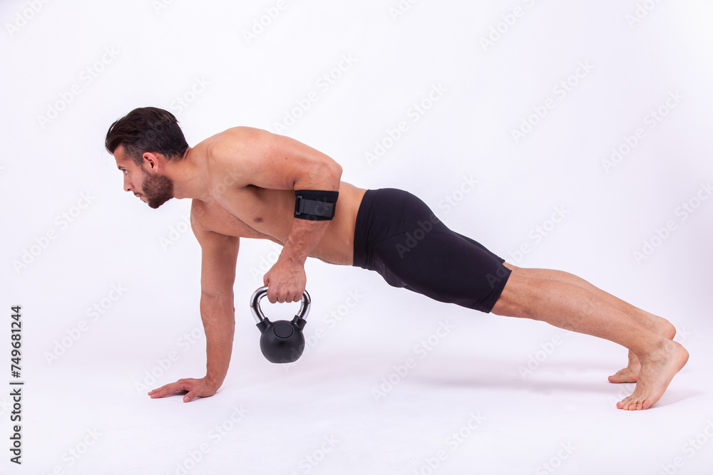 Athlete with dumbbells in hands on a light background Athlete with dumbbells in hands on a light background