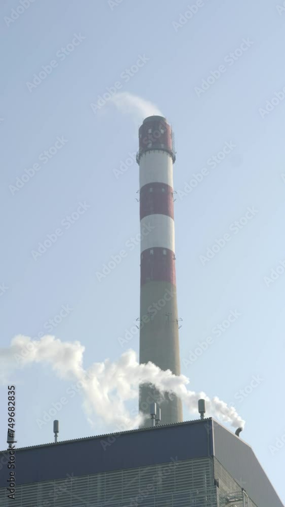 Smoke clouds coming out of factory chimney. Air pollution and global warming caused by old industrial power plant Smoke clouds coming out of factory chimney. Air pollution and global warming caused by old industrial power plant